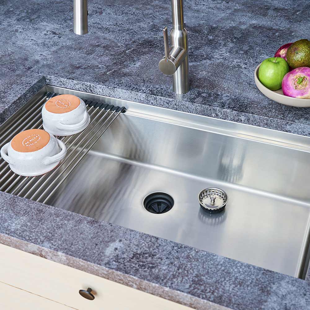 Installed 33-inch stainless steel workstation sink with roll-up drying rack. Single bowl undermount design enhances kitchen functionality and style.