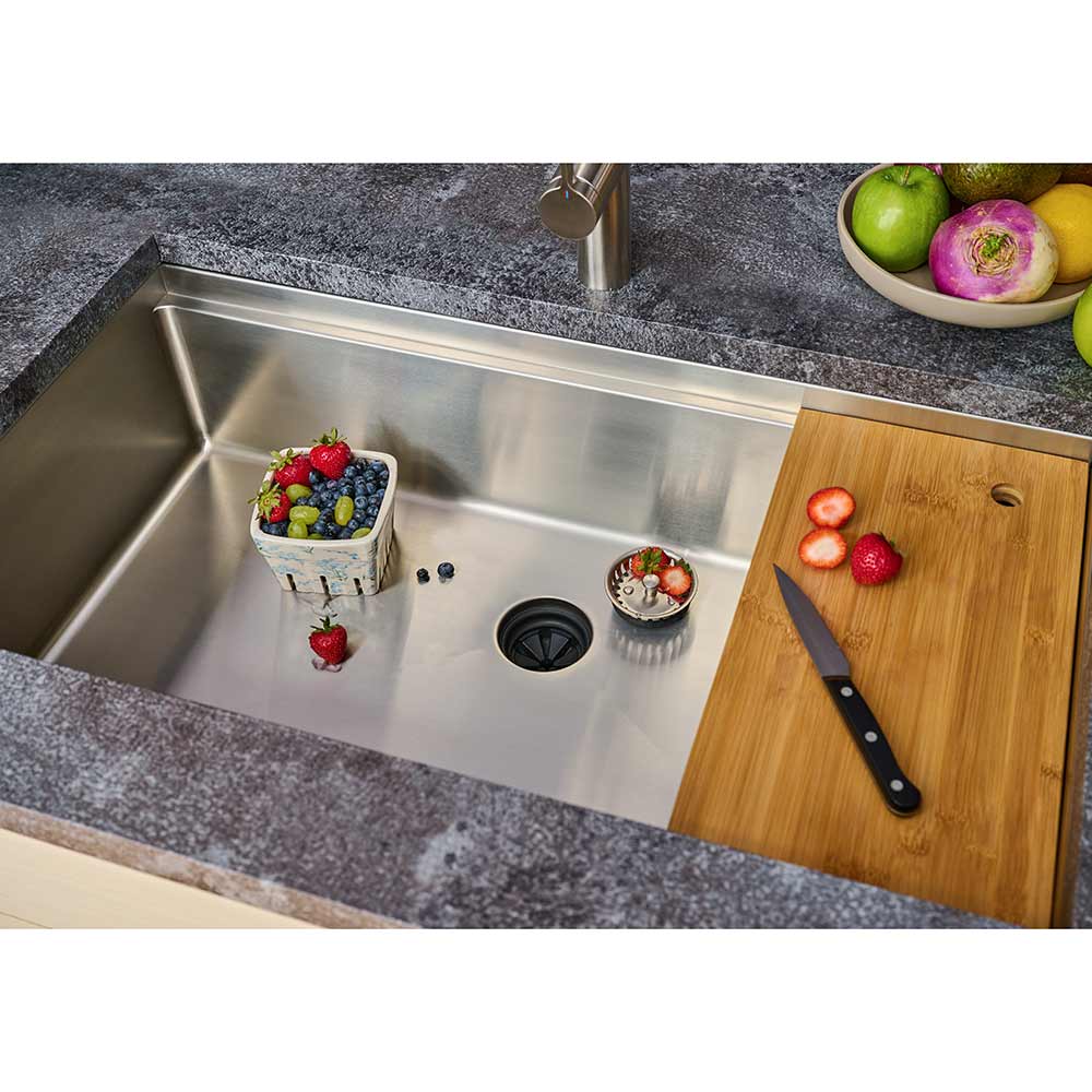 33-inch stainless steel workstation sink with bamboo cutting board and fresh produce. Single bowl undermount design for a functional and stylish kitchen.