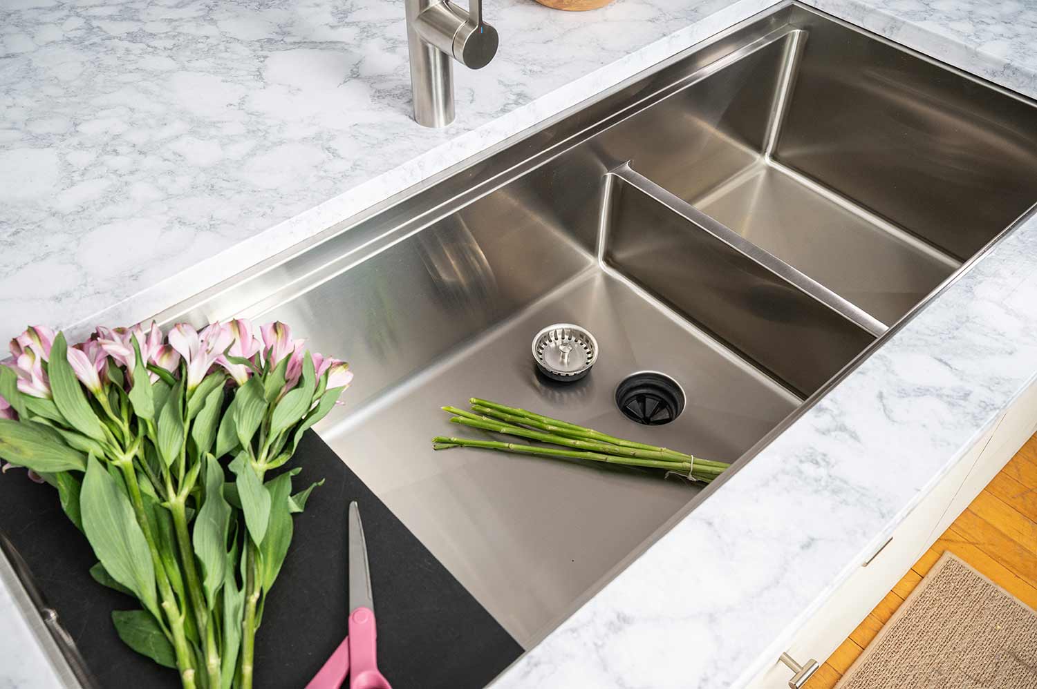 50 inch 16 gauge stainless steel undermount double bowl workstation sink with offset drain. This sink features a low divide and our patented seamless undermount drain with black cutting board. 