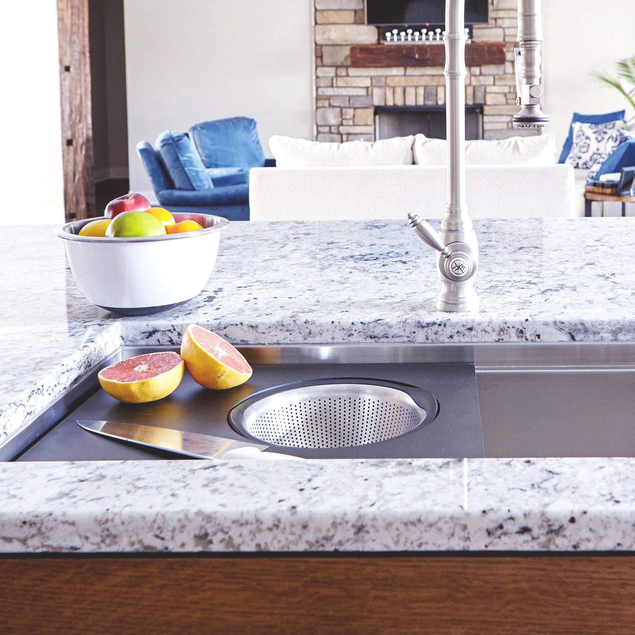 Workstation sink setup with an 18-inch black cutting board and stainless steel colander, ideal for straining and food preparation.