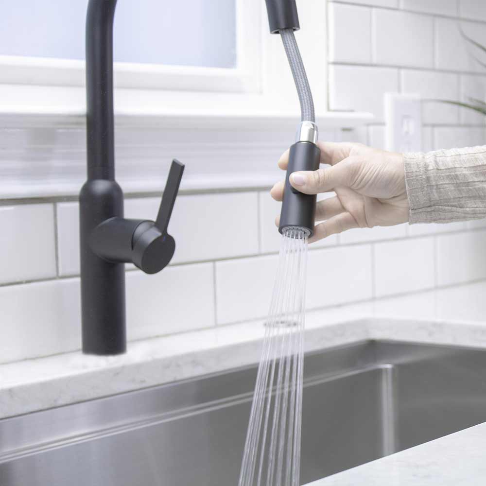 Tall simple matte black kitchen faucet with spray function for washing berries paired with 33 inch stainless steel workstation sink