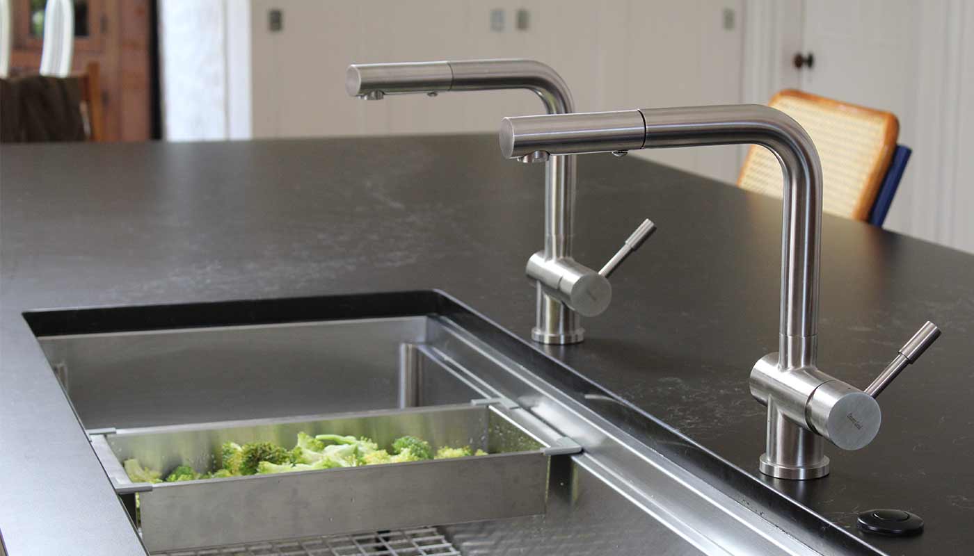 Large workstation kitchen sink with two faucets