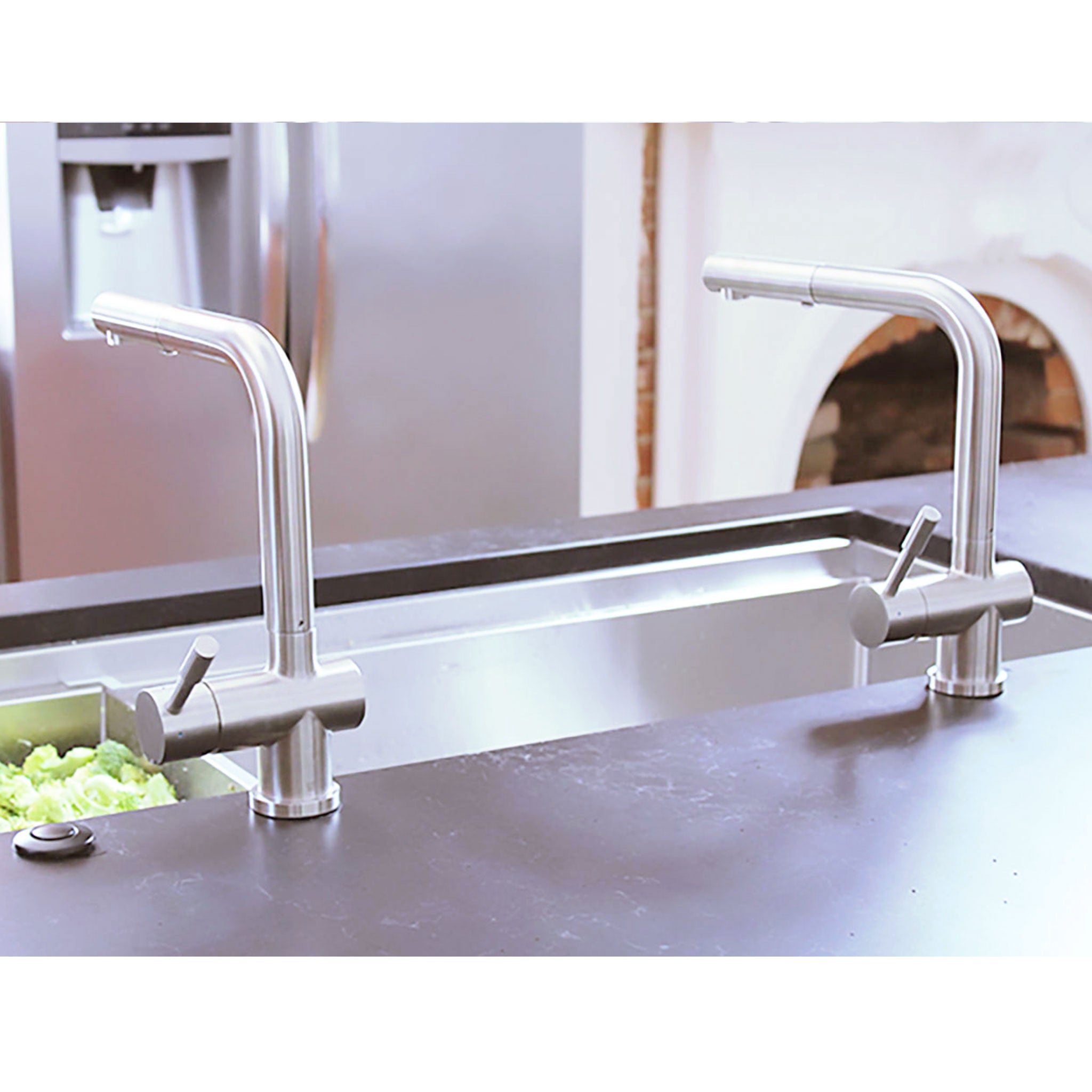 Dual Ardell Stainless Steel Kitchen Faucets installed on a contemporary kitchen island sink, showcasing their modern angular design.