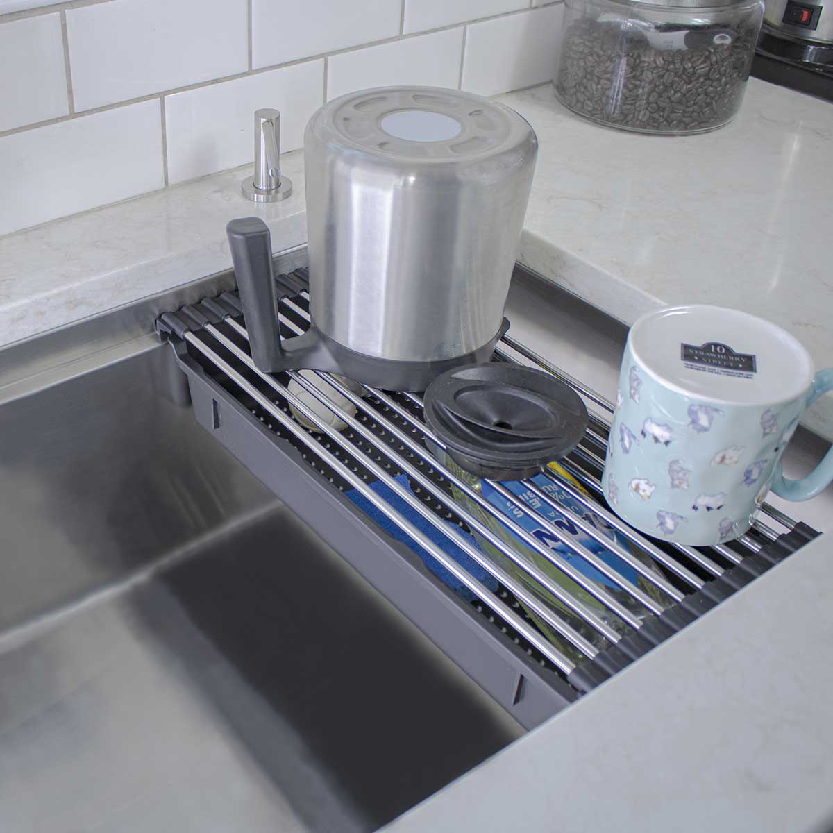Condensed kitchen organization inside of an undermount stainless steel sink basin.