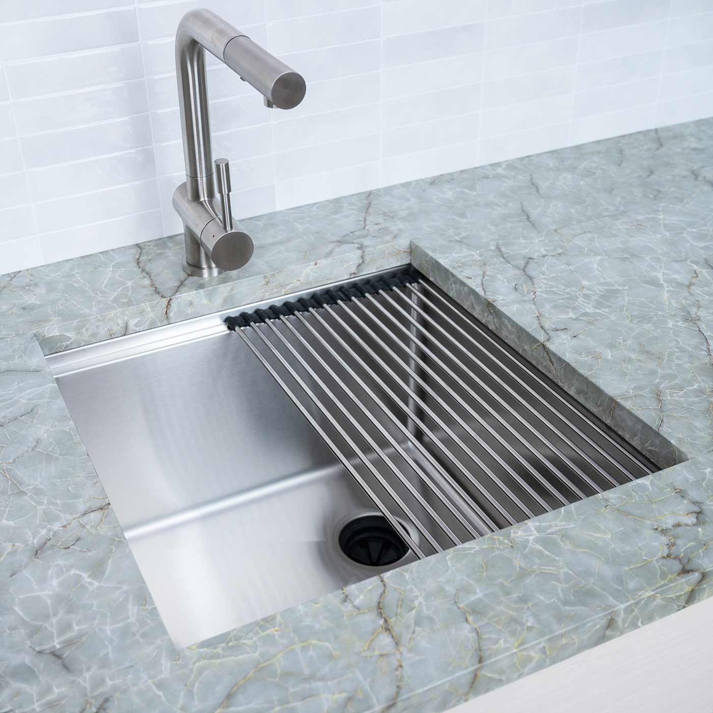 19-inch stainless steel undermount prep sink with a roll-up drying rack. Installed in a modern kitchen with a marble countertop.