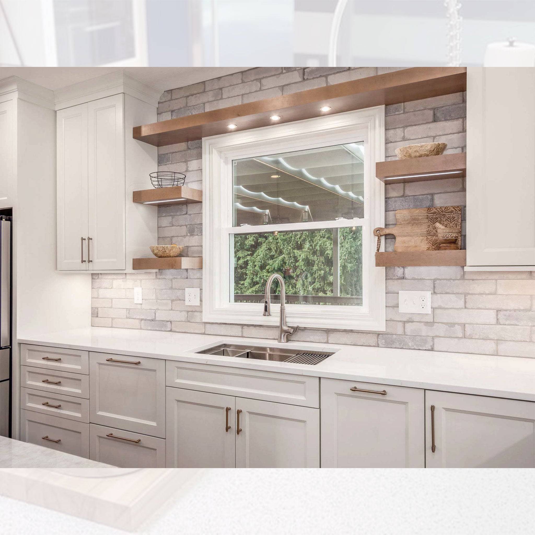 Modern kitchen with a 33-inch stainless steel workstation sink. The single bowl sink features an 8-inch depth and reversible drain for convenience.