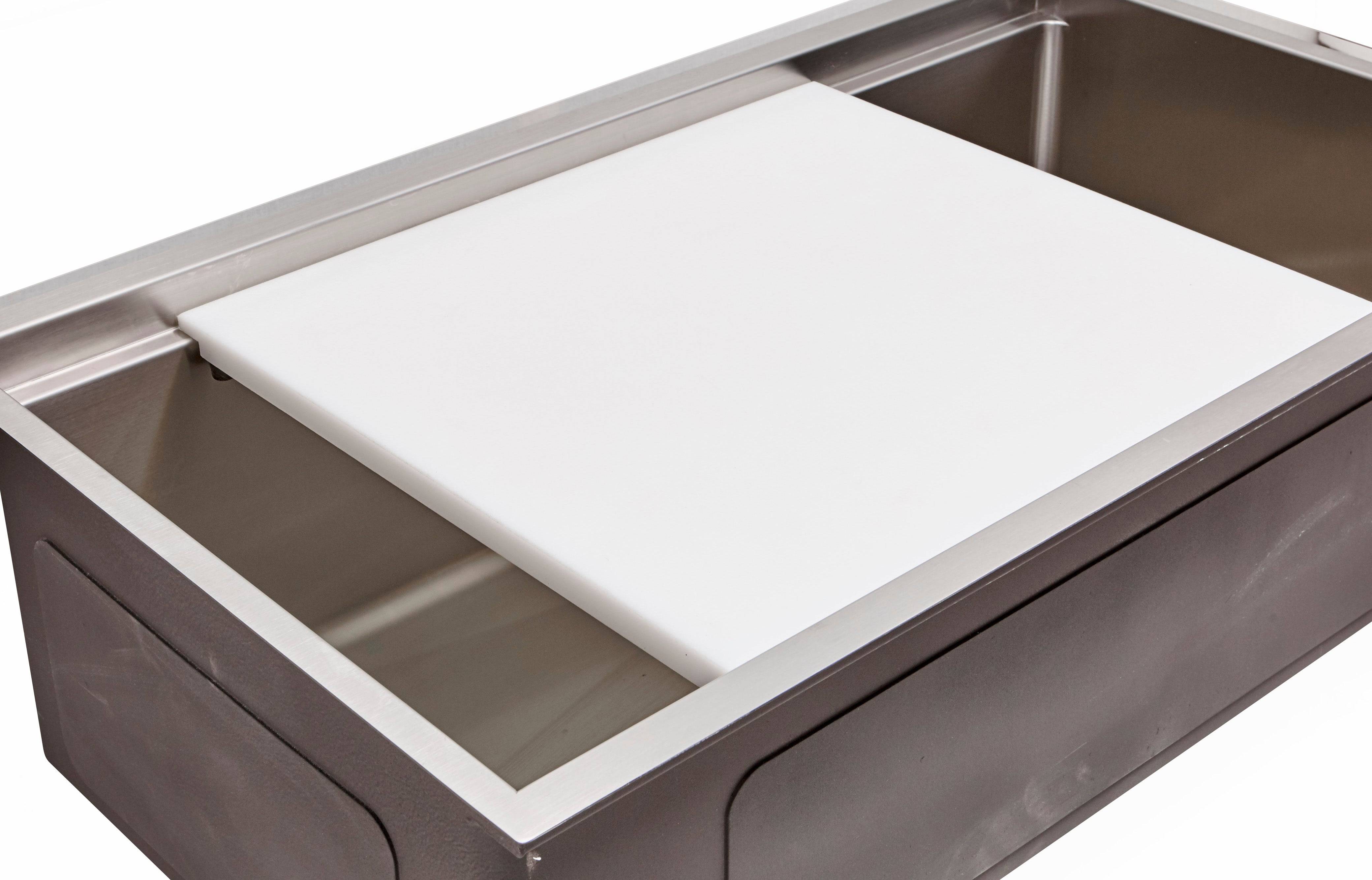 White cutting board designed to fit over a workstation sink, providing a hygienic and sturdy surface for food preparation.