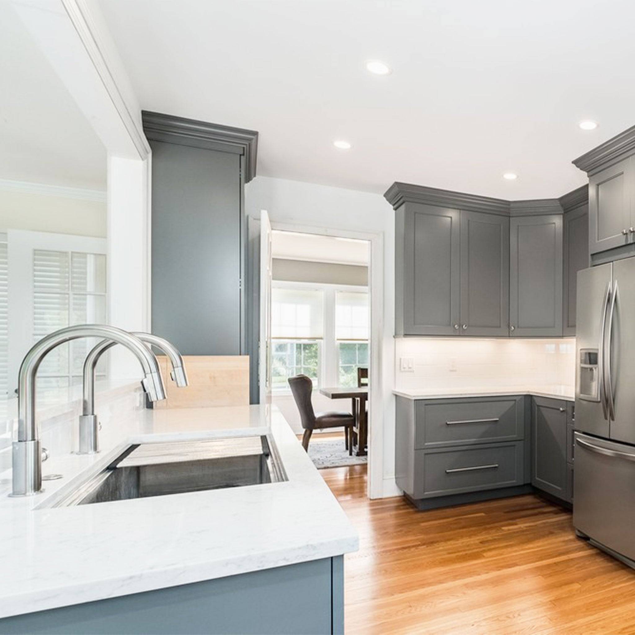 Spacious kitchen featuring a 46-inch double bowl workstation sink with a sleek stainless steel finish, integrated into a modern gray cabinetry design.