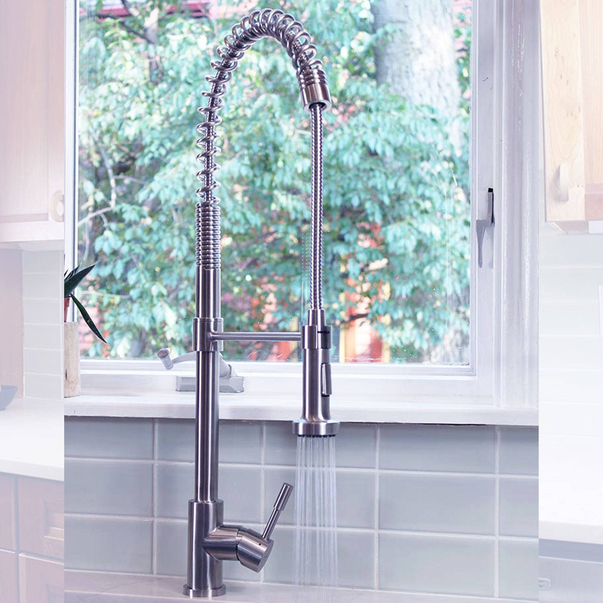 Jerry kitchen sink faucet in stainless steel with a pull-down spray head, demonstrating water flow in a modern kitchen setting.
