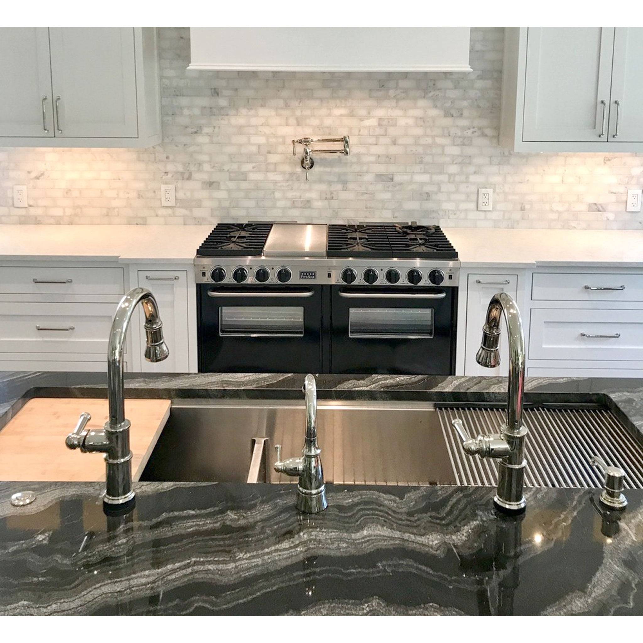 Modern kitchen featuring a 63-inch stainless steel workstation sink with dual faucets and integrated accessories for efficiency.