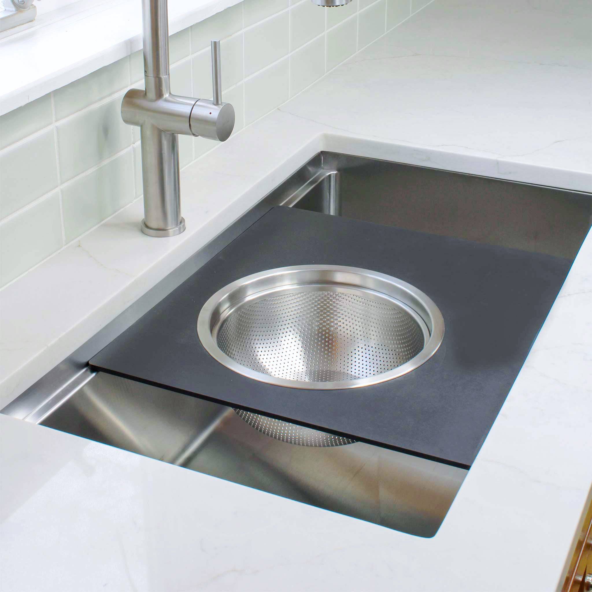 18-inch black cutting board with stainless steel colander, designed for workstation sinks. Ideal for efficient food prep and straining.
