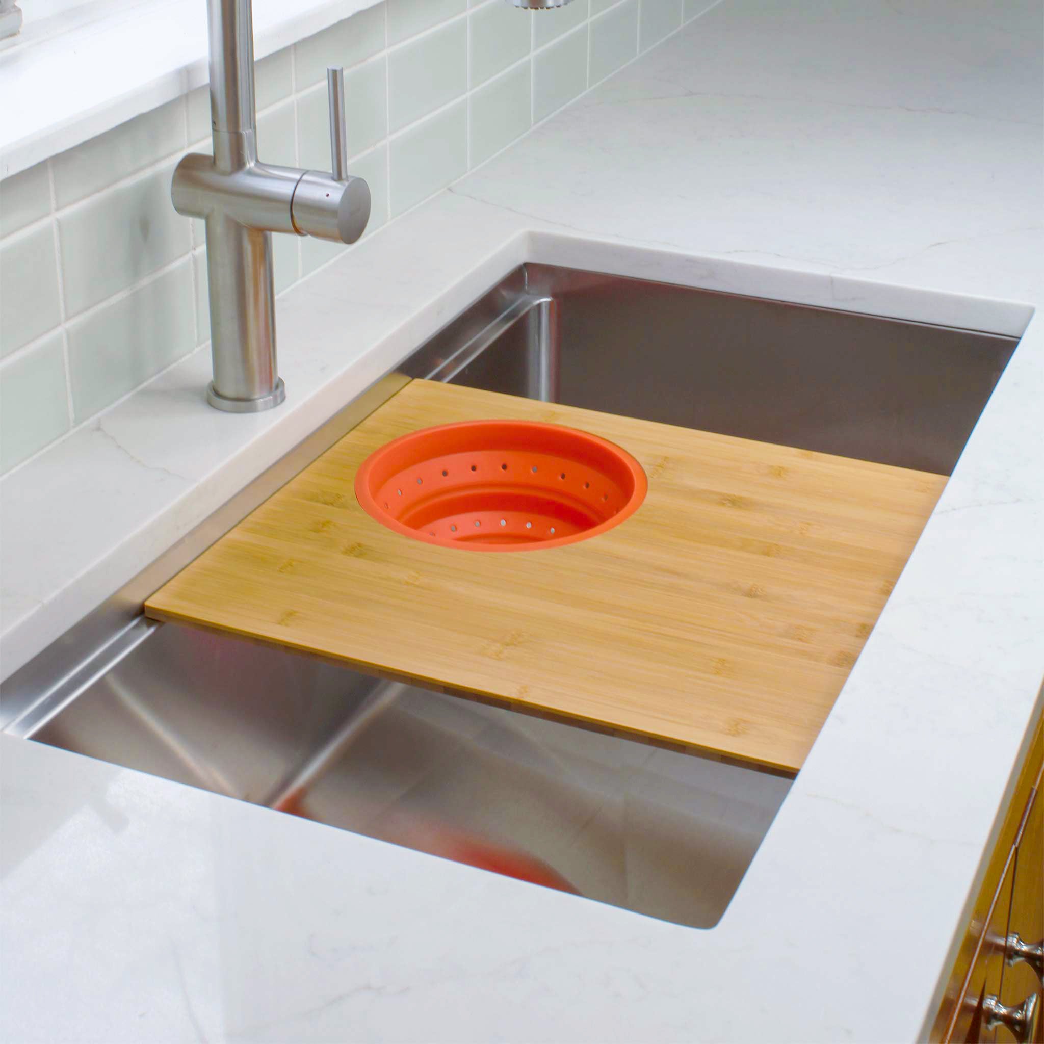 Seamless drain workstation sink with cutting board and silicone colander in Carrot Orange from Create Good Sinks