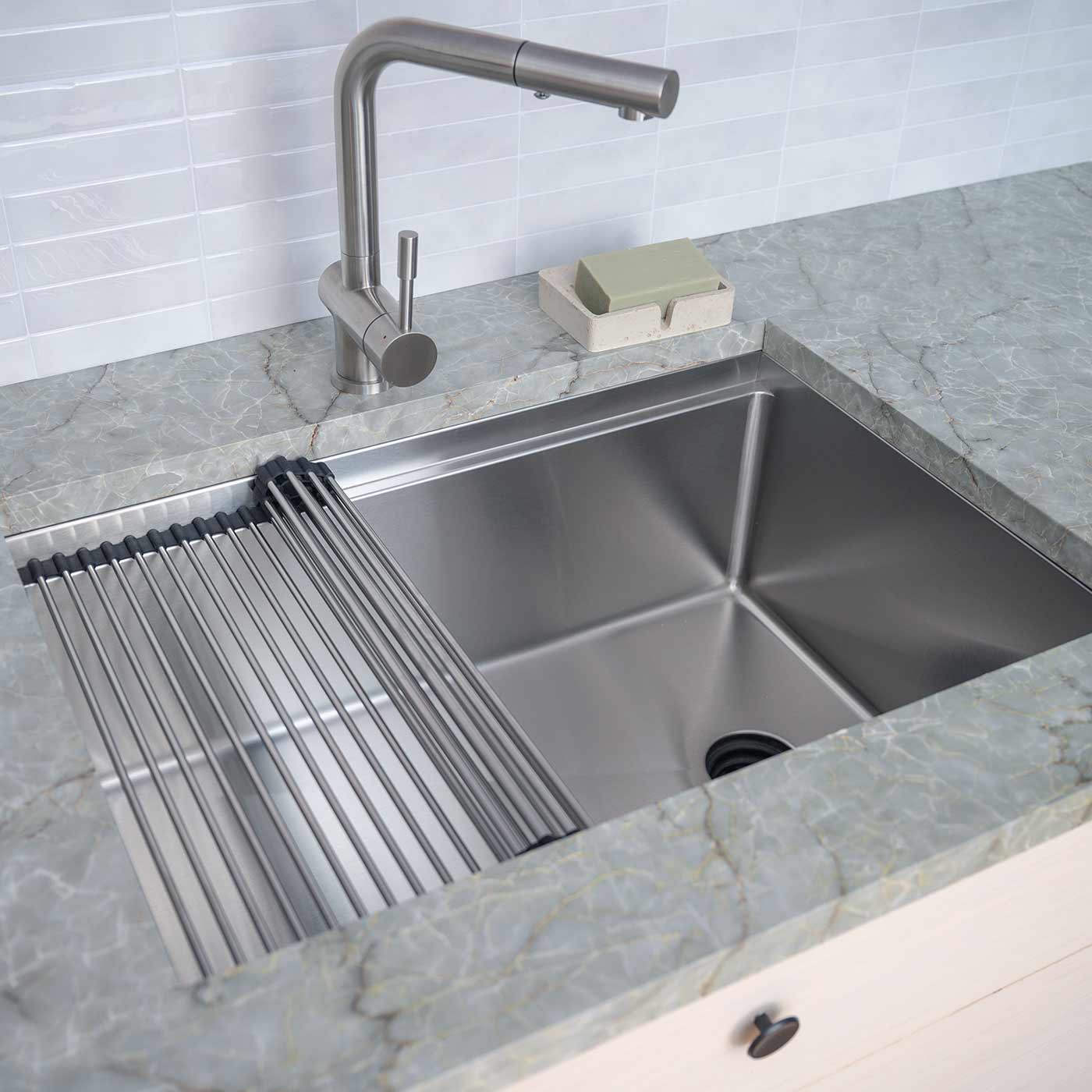 28 inch workstation sink made with 16 gauge stainless steel and offset reversible seamless drain with stainless steel roll up drying rack