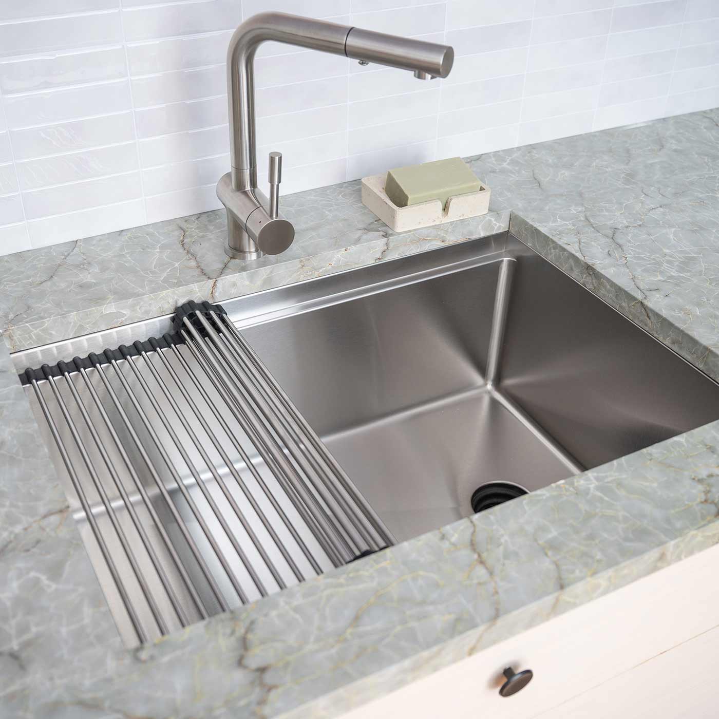 Stainless steel workstation kitchen sink with a roll-up drying rack and undermount installation, designed for efficiency and style in contemporary kitchens.