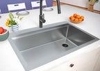 33 inch drop in top mount single bowl workstation sink made with 16 gauge stainless steel with offset drain to the right side installed in kitchen island with matte black faucet
