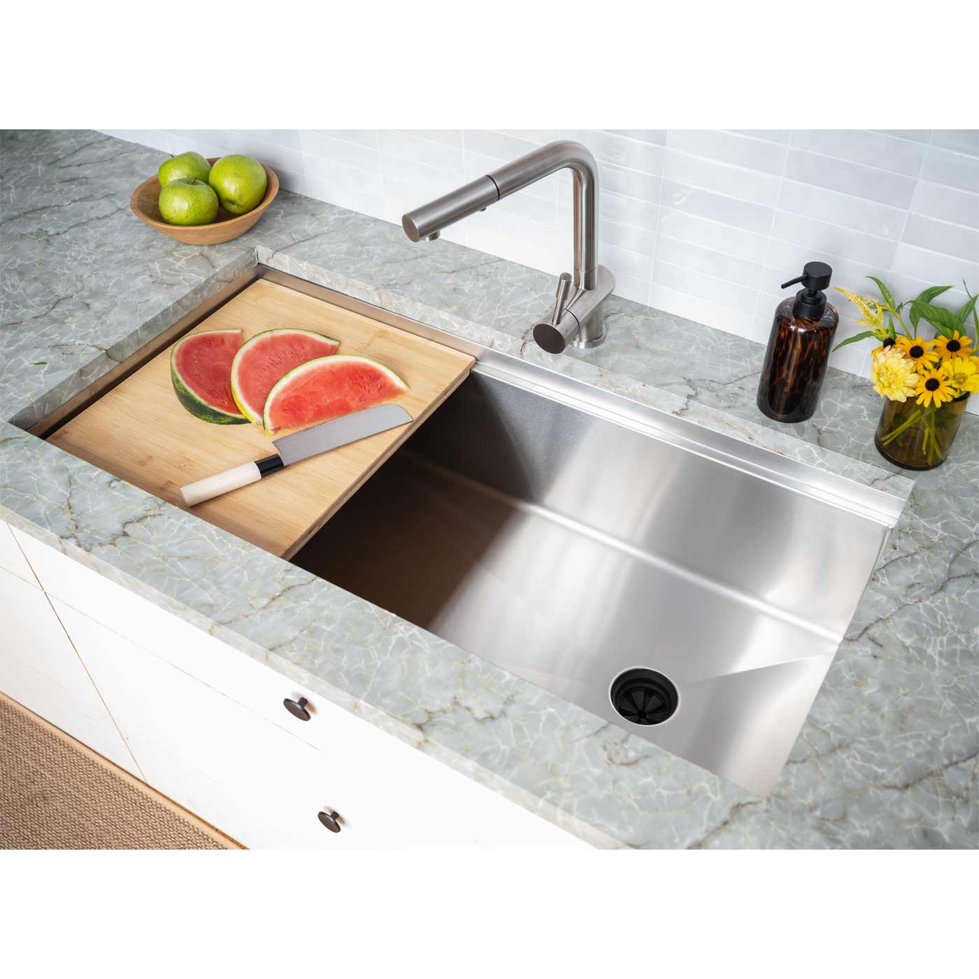 40-inch stainless steel workstation sink with a built-in ledge, featuring a cutting board and fresh watermelon for convenient food prep.