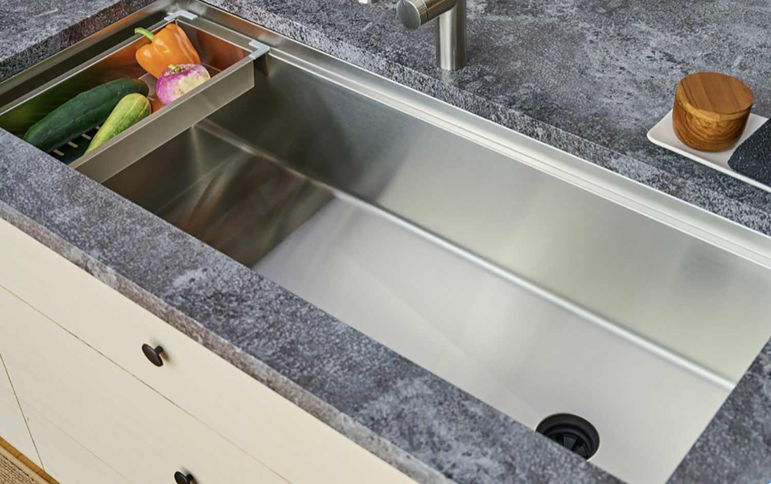 Large trough style workstation sink with single basin and offset drain