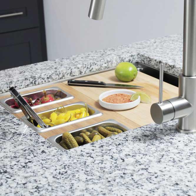22-inch stainless steel workstation sink with integrated ledge, featuring food prep accessories like cutting board and storage trays.