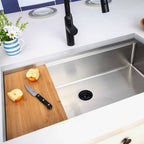 Modern 33-inch workstation sink with bamboo cutting board and center drain. Stainless steel single bowl undermount design for versatile kitchen use.