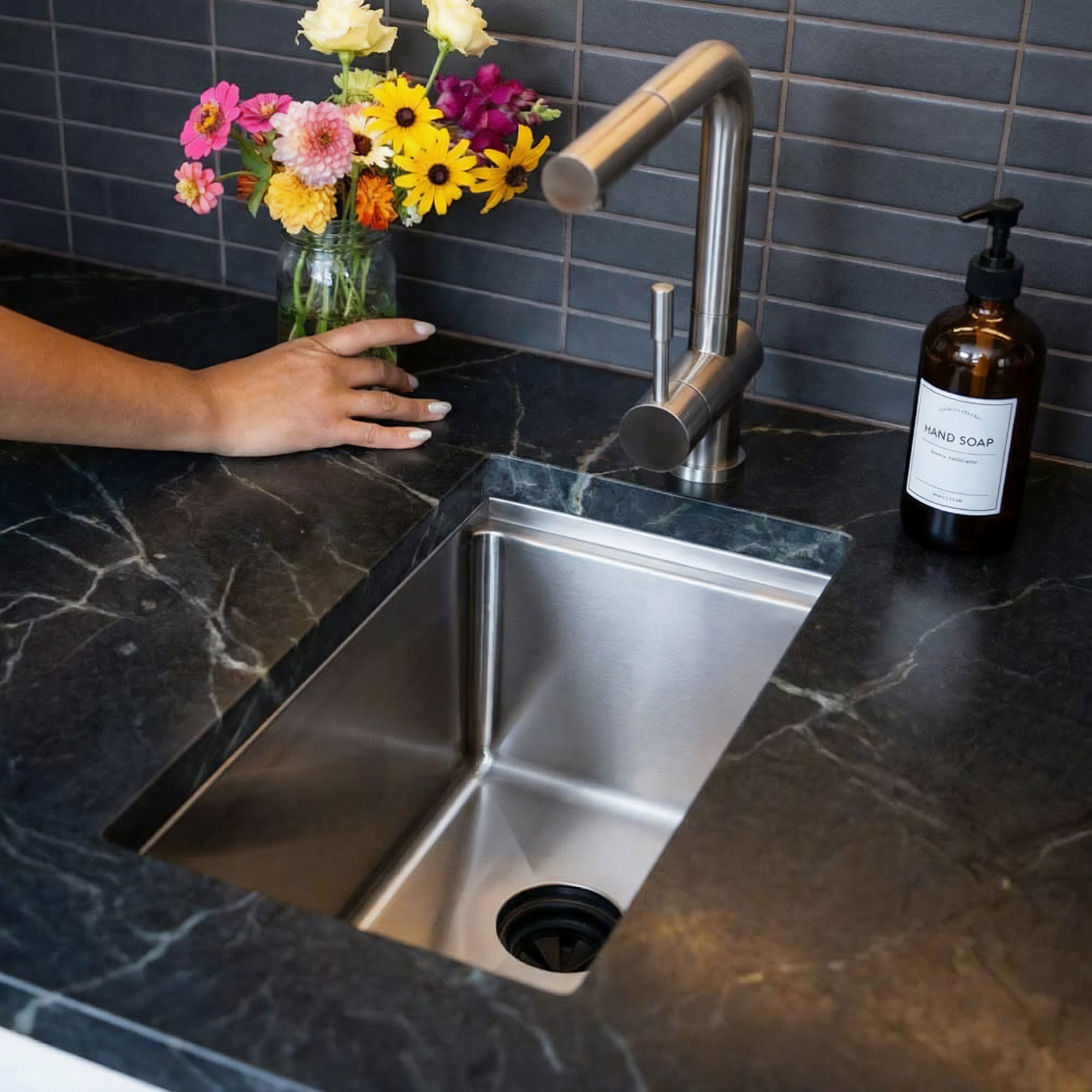 Ten inch Stainless steel undermount workstation bar sink installed in black quartz counter