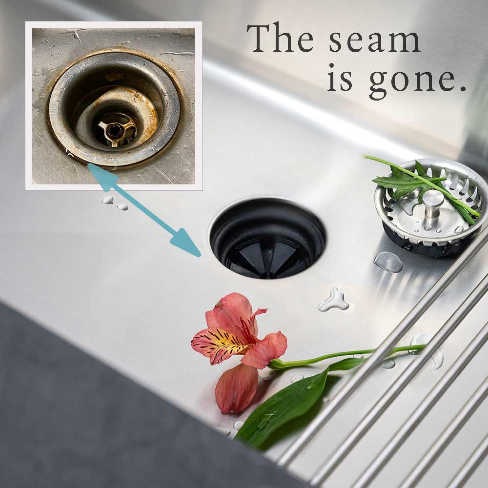 Close-up of seamless stainless steel undermount kitchen sink with offset drain, highlighting its smooth, easy-to-clean surface and modern design.