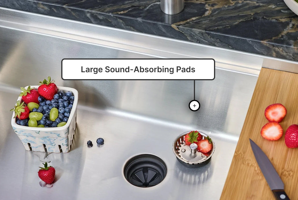 Large sound-absorbing pads on the underside of a stainless steel kitchen sink