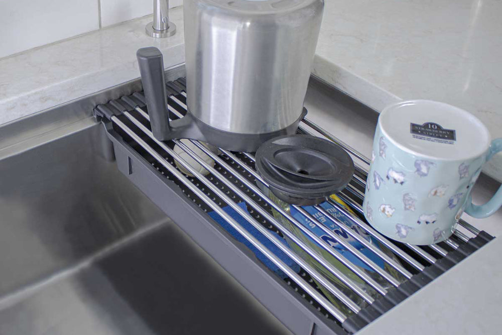 Condensed kitchen organization inside of an undermount stainless steel sink basin.