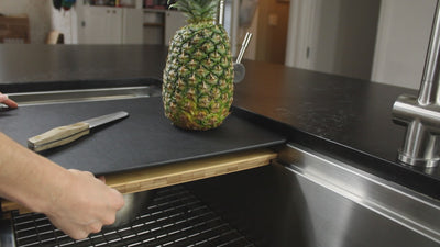 The double ledge effect in a workstation sink allows multiple sink accessories to slide on the dual tiers