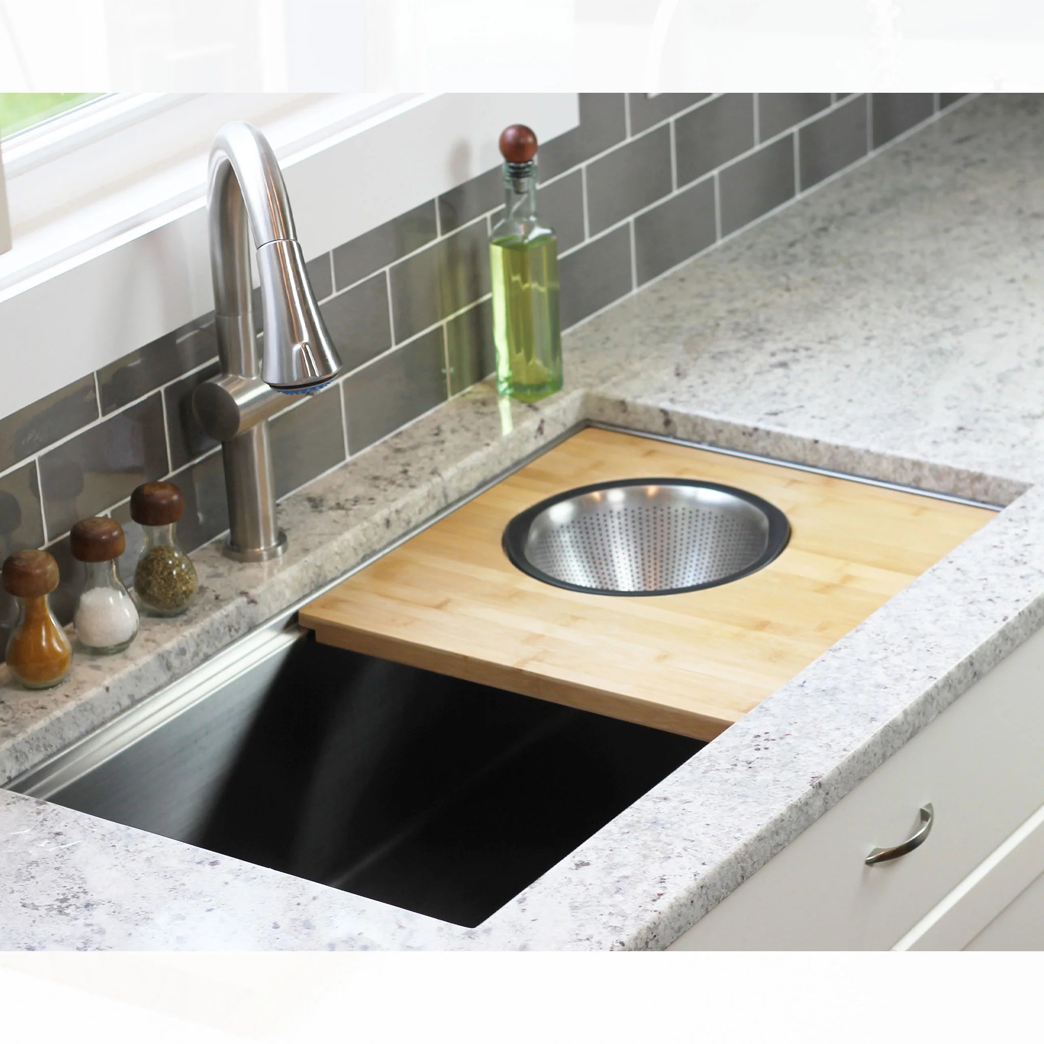 33 inch single basin stainless steel undermount kitchen sink. Workstation sink design with colander and cutting board accessory. Installed in quartz counters