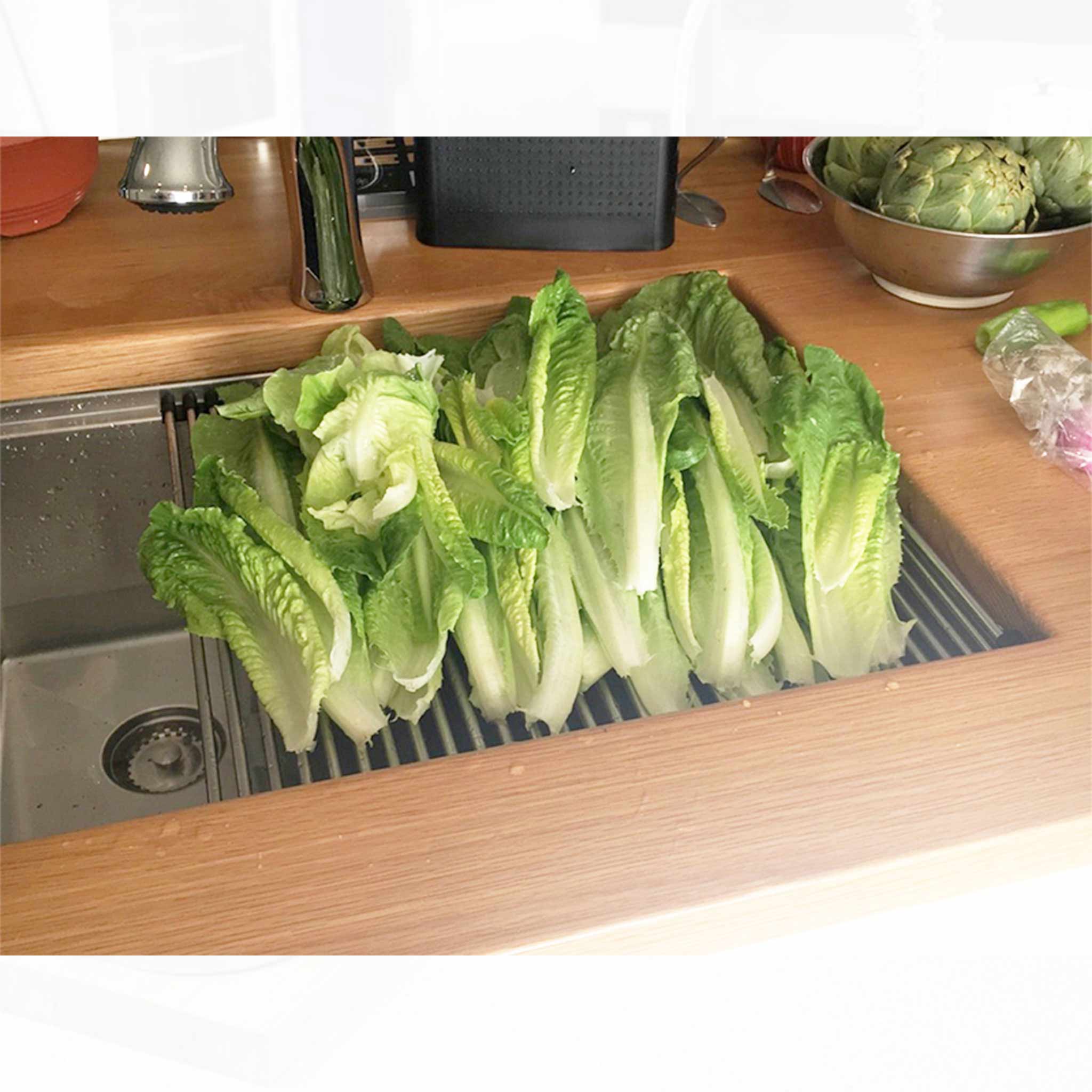 Customer photo of our 26" workstation sink installed in butcher block counter. Features offset drain left. Made with 16 gauge type 304 stainless steel and designed for undermount installation. Features Create Good Sinks' patented, award-winning seamless drain