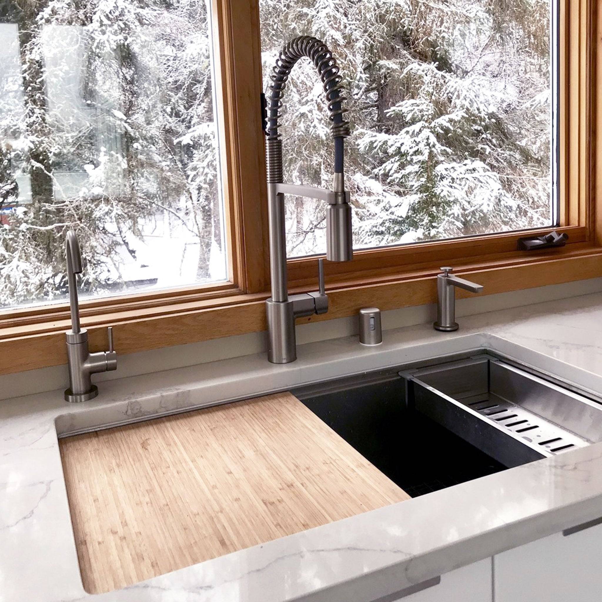 Customer photo of 33 inch workstation sink with bamboo cutting board, stainless steel colander, and stainless steel industrial sink. Undermount sink with undermount seamless drain.