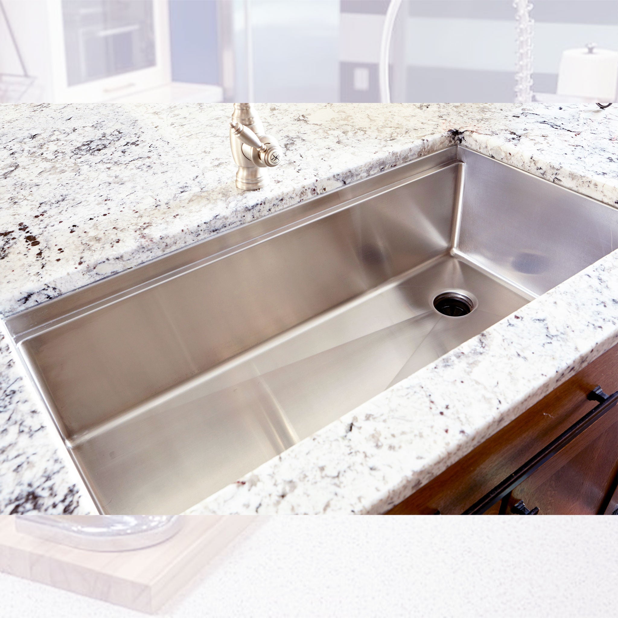 Overhead view of a mid-sized 37” workstation sink and a seamless drain in the corner of the sink’s basin.
