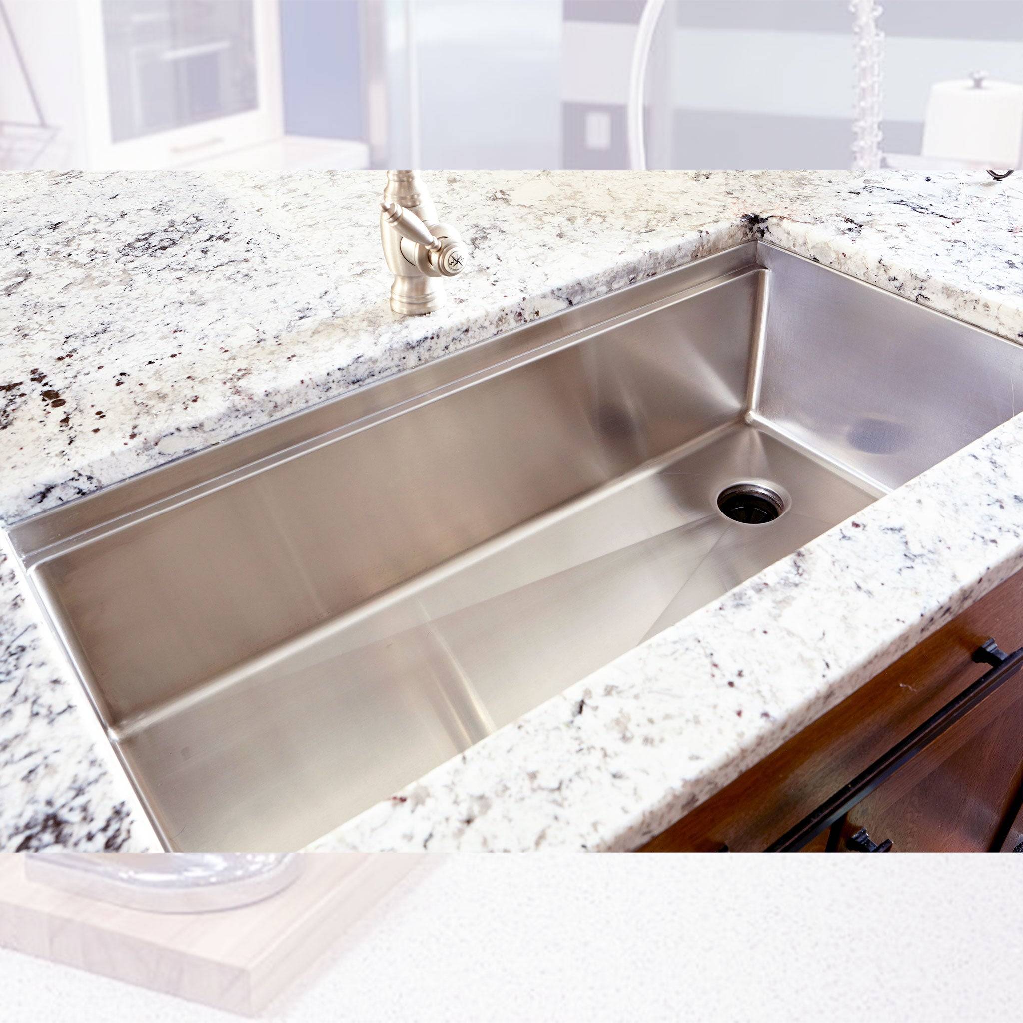Stainless steel 37-inch workstation sink installed in a granite countertop. Offset right drain and spacious single bowl for versatile kitchen use.