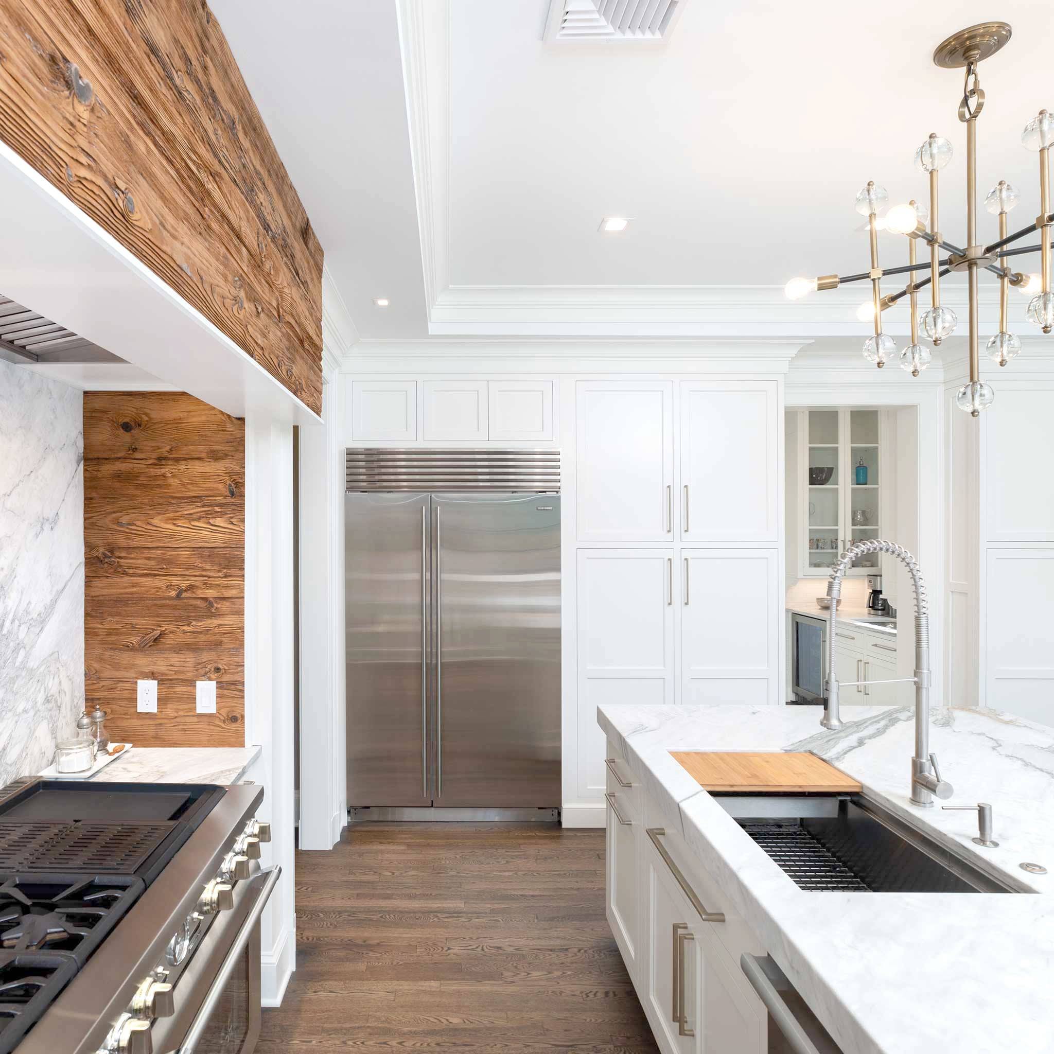 Elegant kitchen with a 46-inch workstation sink, featuring a stainless steel single bowl and offset drain, integrated into a marble countertop.