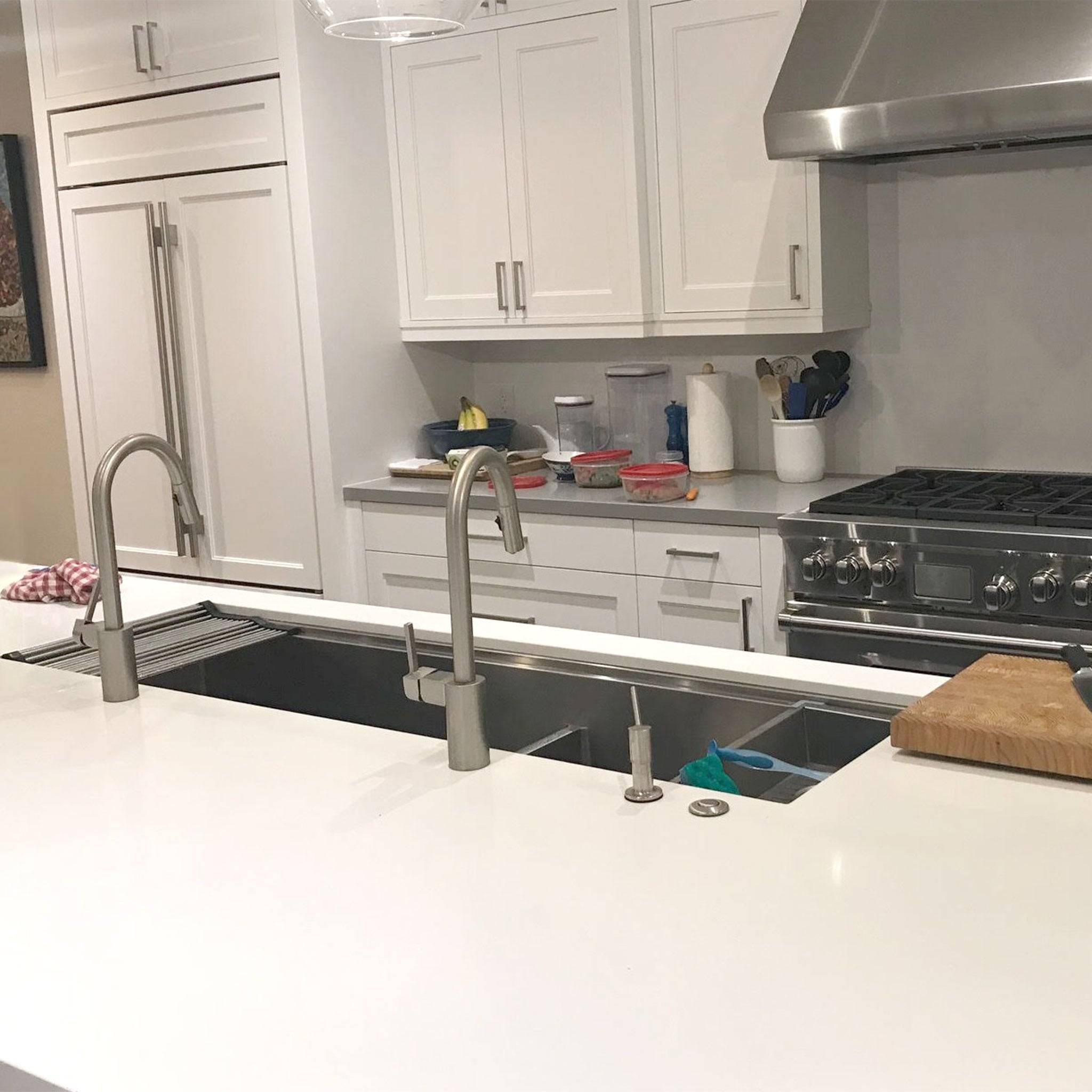 Contemporary kitchen with a 63-inch double bowl workstation sink and dual faucets, enhancing workflow and convenience.