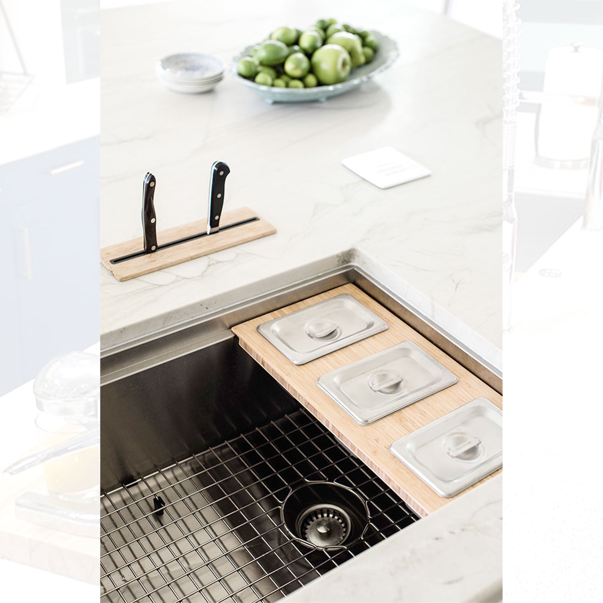 Basin grate and bambo serving board in a 33 inch workstation sink