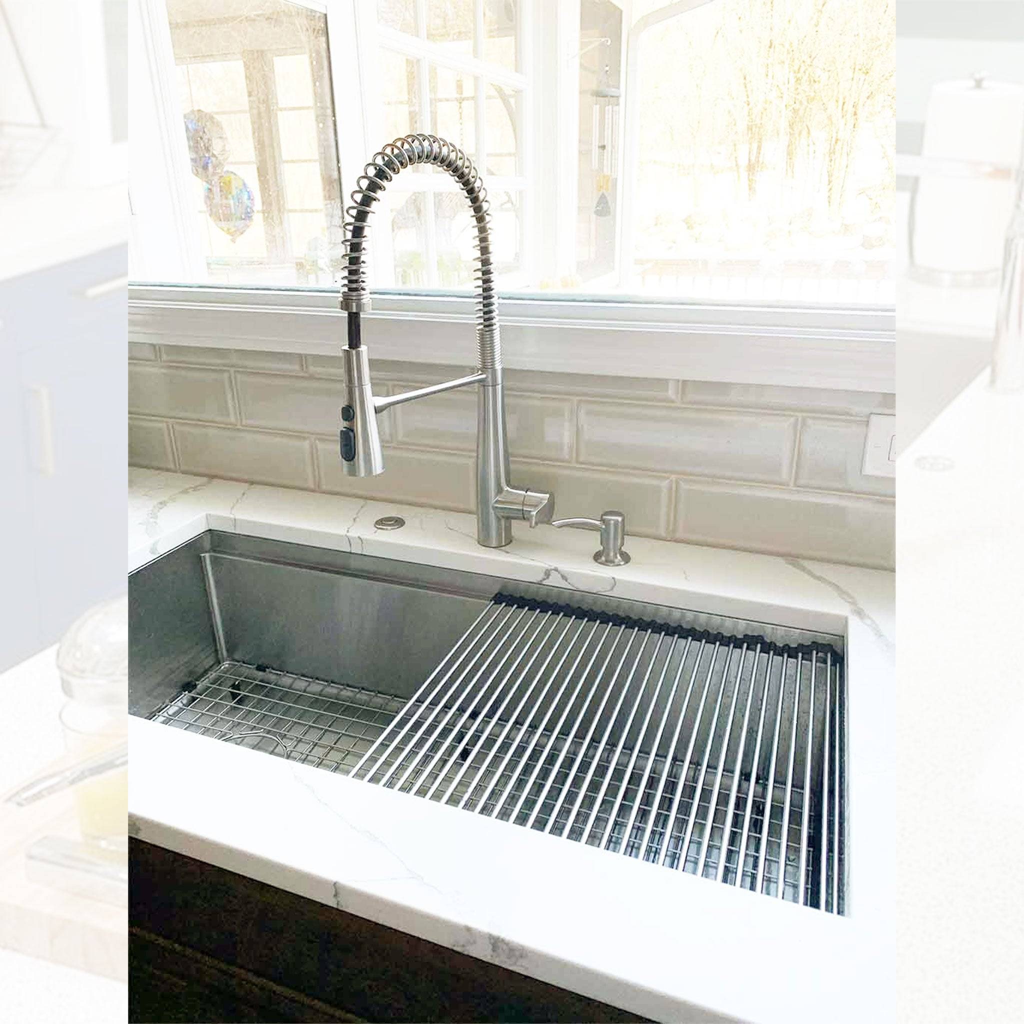40-inch large workstation kitchen sink installed with a high-arc pull-down faucet, featuring a roll-up drying rack and stainless steel grid.
