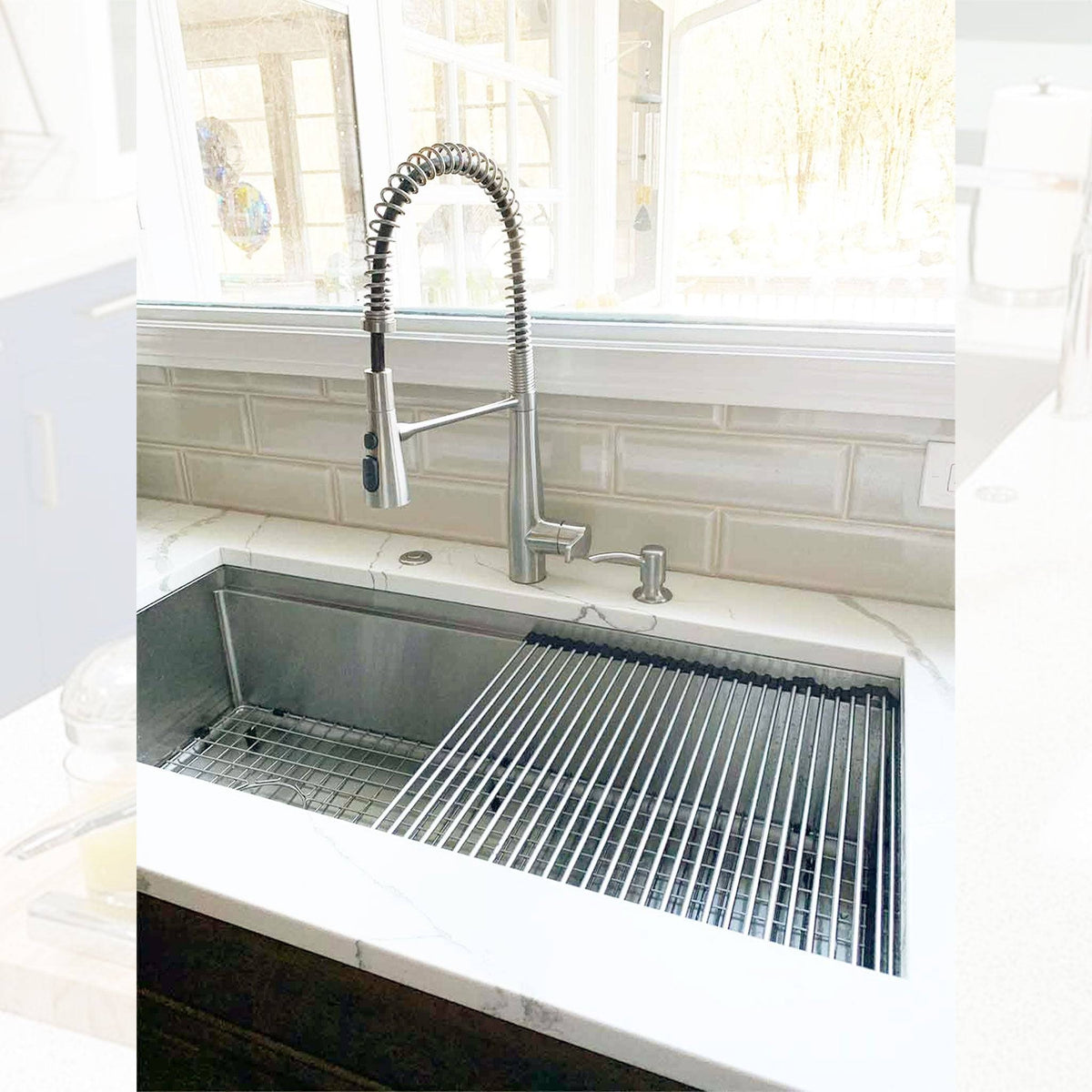 40-inch large workstation kitchen sink installed with a high-arc pull-down faucet, featuring a roll-up drying rack and stainless steel grid.