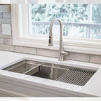 Installed 33-inch stainless steel workstation sink with accessories. Features an 8-inch depth and reversible drain for optimized kitchen workflow.