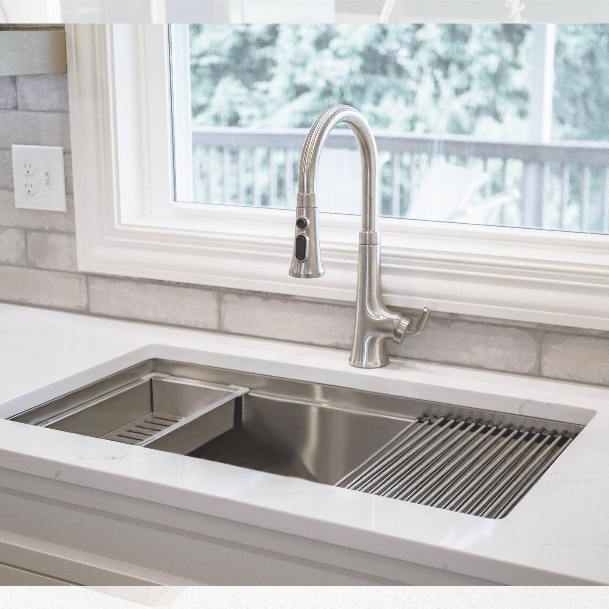 Installed 33-inch stainless steel workstation sink with accessories. Features an 8-inch depth and reversible drain for optimized kitchen workflow.