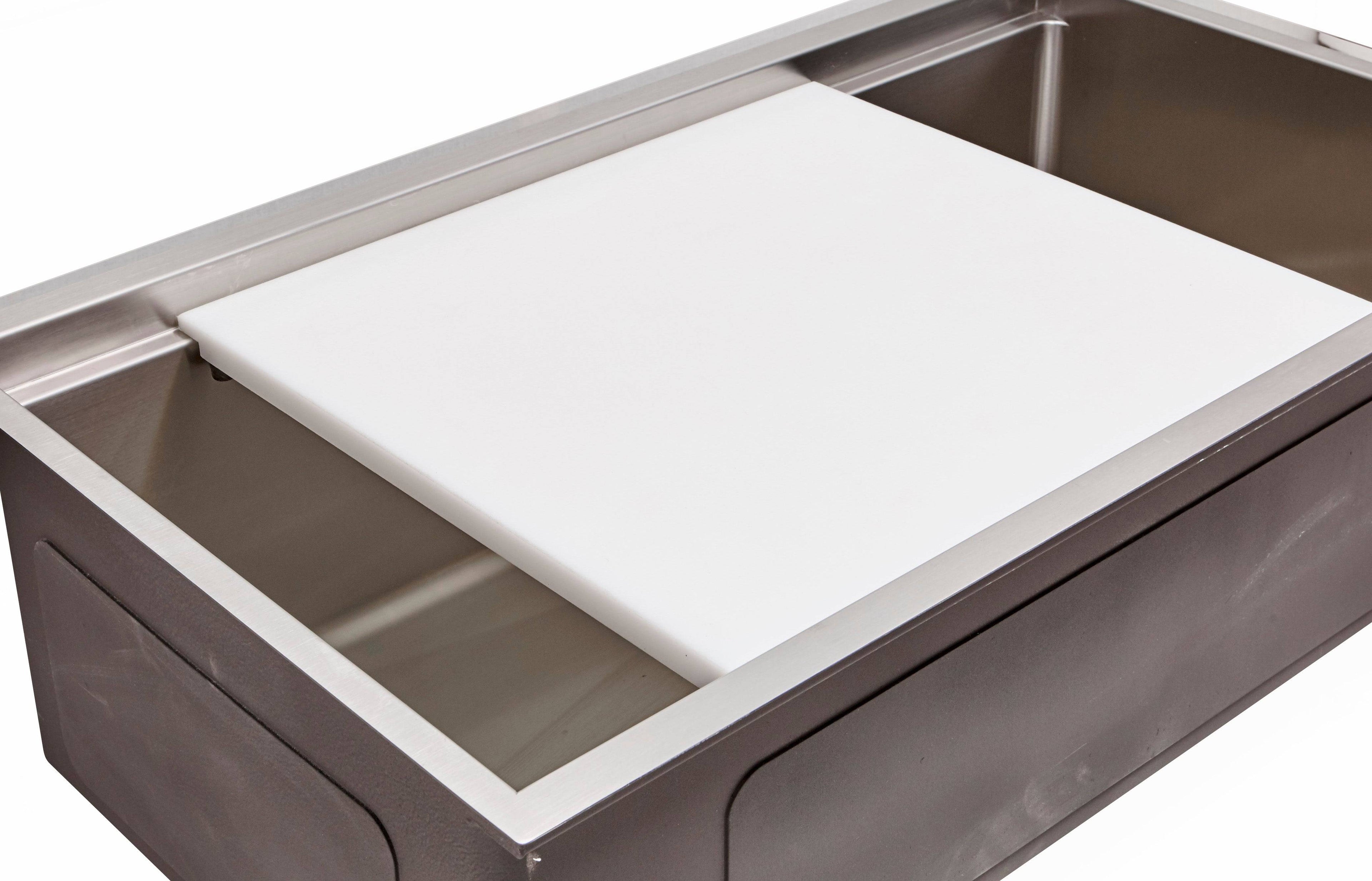 White cutting board designed to fit over a workstation sink, providing a hygienic and sturdy surface for food preparation.