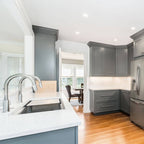 Spacious kitchen featuring a 46-inch double bowl workstation sink with a sleek stainless steel finish, integrated into a modern gray cabinetry design.