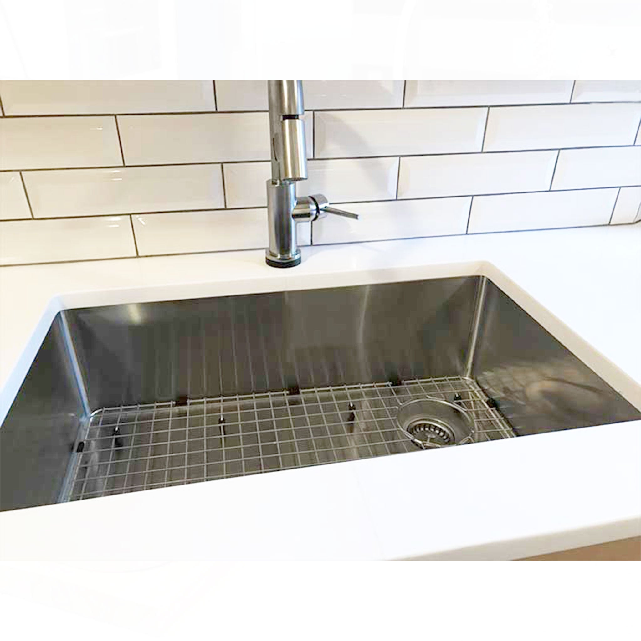 Client picture of a 30”, classic, stainless-steel kitchen sink from Create Good Sinks with a seamless drain and basin grid.