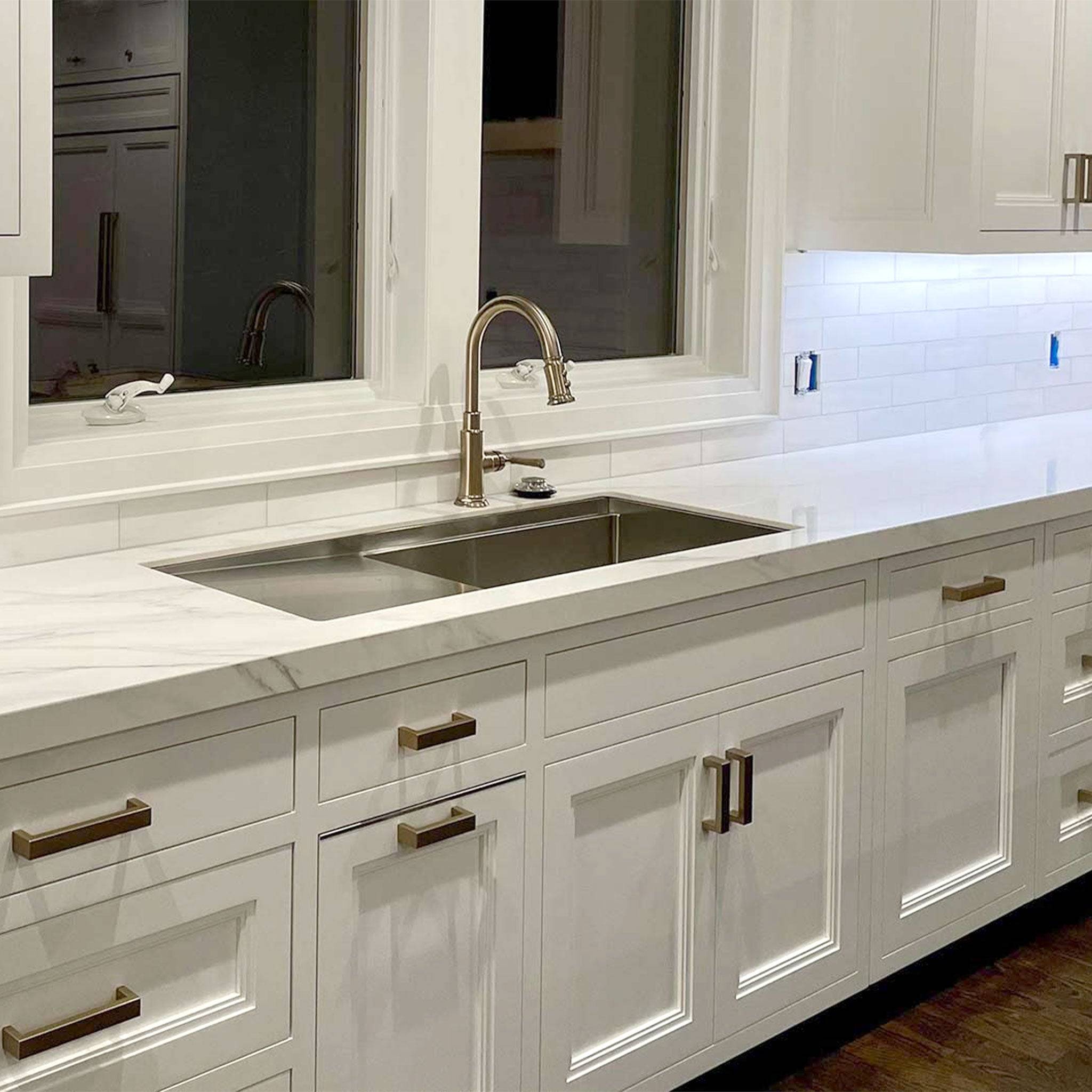 Drainboard workstation stainless steel sink installed in a kitchen counter.