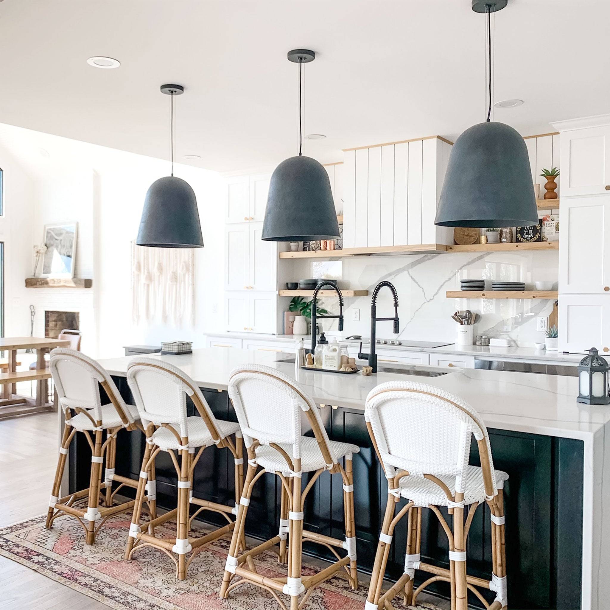 Luxury kitchen featuring a 46-inch workstation sink with dual black faucets, stylish pendant lighting, and a modern island setup.