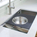 18-inch black cutting board with stainless steel colander, designed for workstation sinks. Ideal for efficient food prep and straining.
