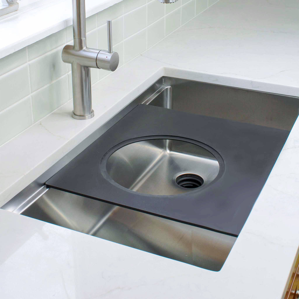 18-inch black cutting board with a circular cutout, designed for workstation sinks. Versatile accessory for seamless kitchen prep.