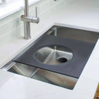 18-inch black cutting board with a circular cutout, designed for workstation sinks. Versatile accessory for seamless kitchen prep.