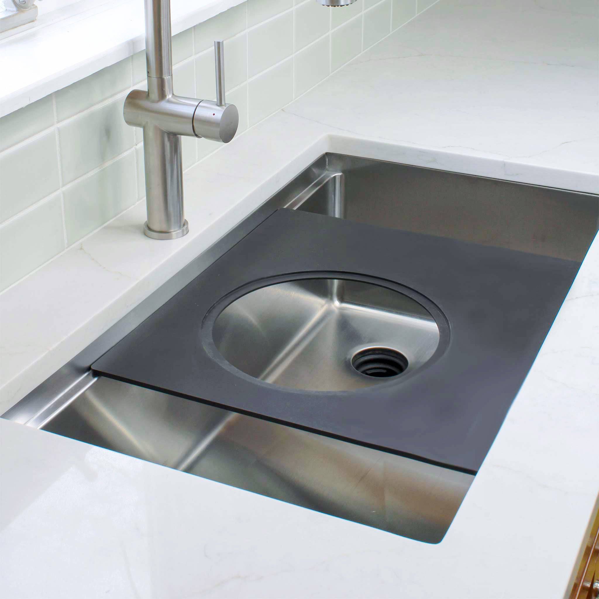 18-inch black cutting board with a circular cutout, designed for workstation sinks. Versatile accessory for seamless kitchen prep.