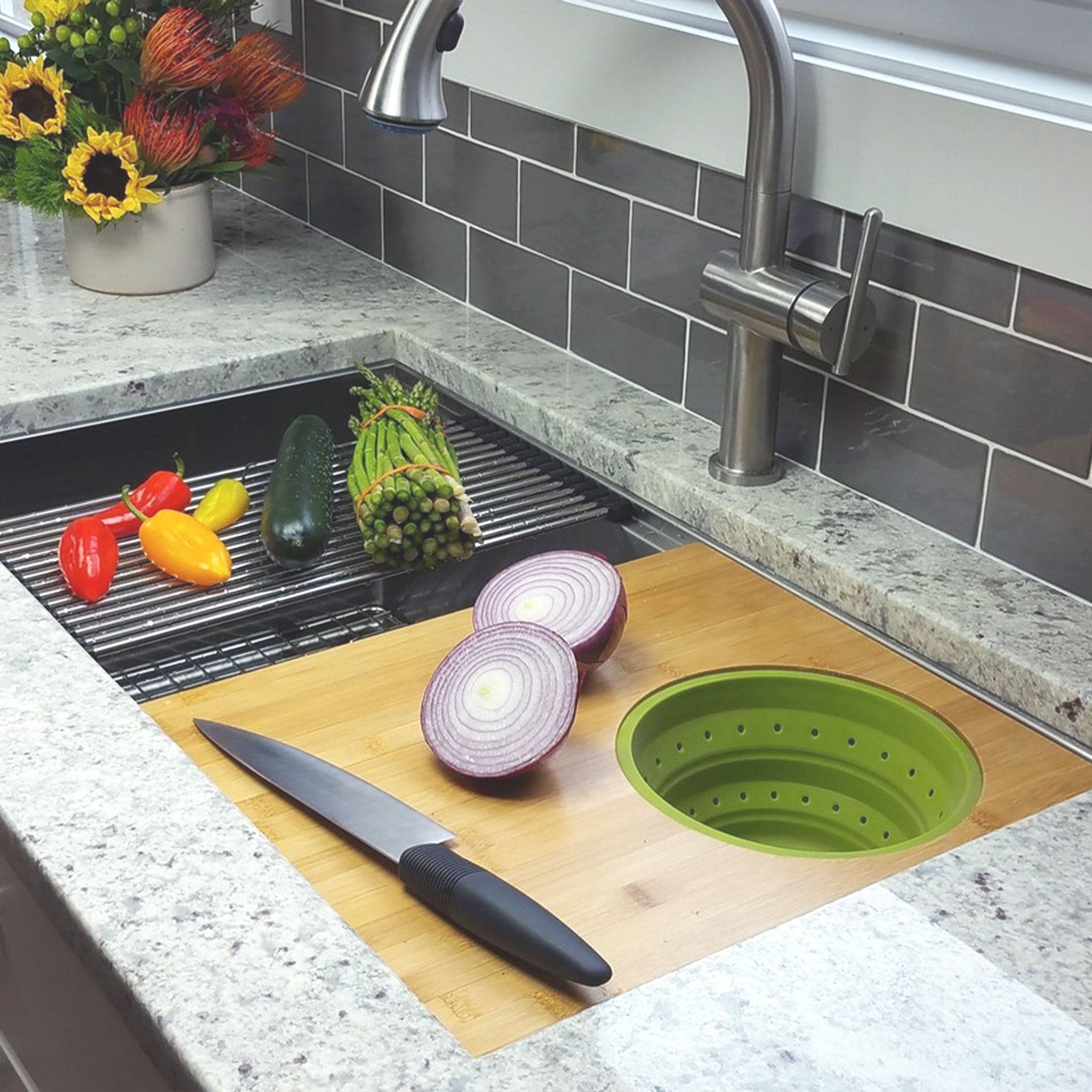 Seamless drain workstation sink with cutting board and silicone colander in Carrot Orange from Create Good Sinks